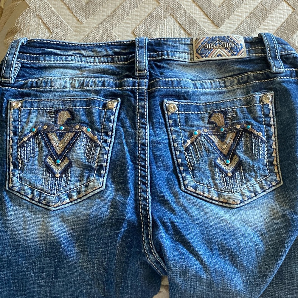 Medium wash Miss Me Thunderbird pocket boot cut jeans